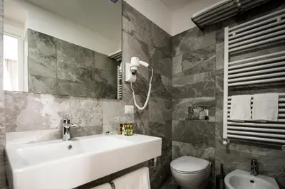 a bathroom with a sink and a toilet at Vinci House in Rome