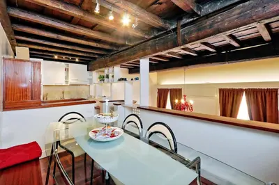 a kitchen with a table and chairs in a kitchen at Pantheon Family Junior Suite in Rome