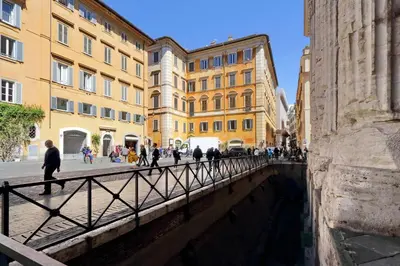 a group of people walking on a bridge over a canal at Pantheon Family Junior Suite in Rome