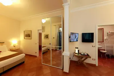 a hotel room with a bed and a mirror at Residenza Gens Julia in Rome