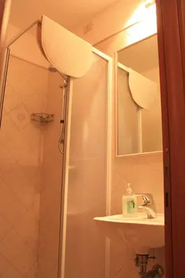 a bathroom with a shower and a sink and a mirror at Hotel Campidoglio in Rome