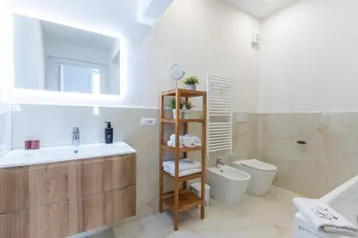 a white bathroom with a sink and a toilet at Rental in Rome - Bramante Luxury in Rome