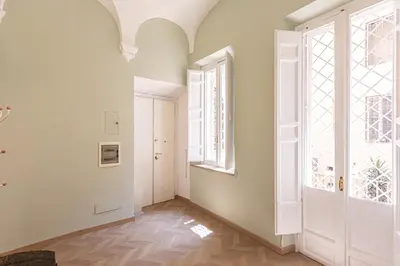 an empty hallway with a large window and a door at Rental in Rome - Bramante Luxury in Rome