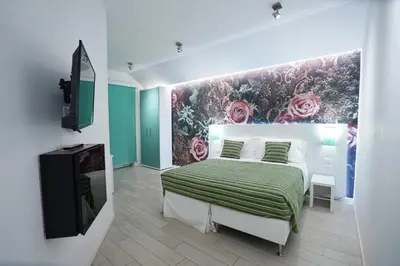 a bedroom with a bed and a tv in it at Duca's House in Rome