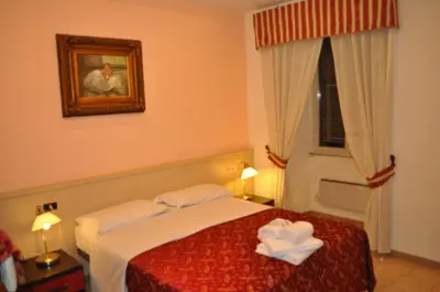 a bedroom with a bed with two towels on it at B&B Sergio House in Rome
