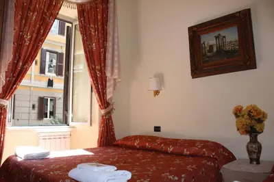 a hotel room with a bed and a window at B&B Sergio House in Rome