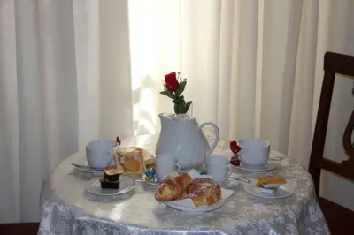 a table with croissants and tea cups on it at Guest House Galaxy in Rome