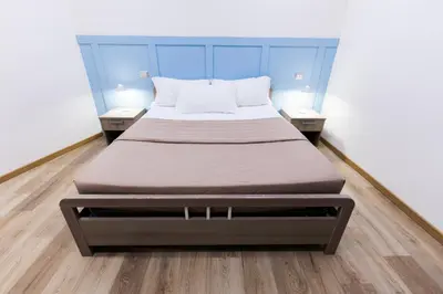 a large bed in a room with two night stands at La Vite Vaticana in Rome