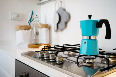 a blue coffee maker sitting on top of a stove at Beautiful designer apartment close to Pantheon in Rome