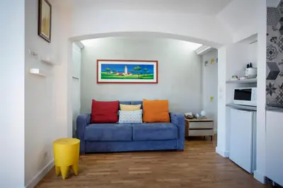 a living room with a blue couch with colorful pillows at Argentina apartment Roof View in Rome