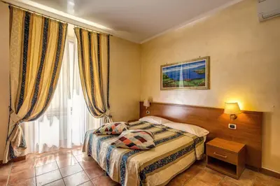 a hotel room with a bed and a window at Hotel Maryelen in Rome