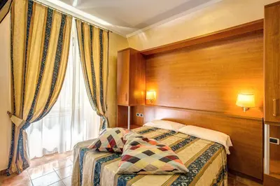 a hotel room with a bed and a window at Hotel Maryelen in Rome
