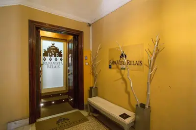a bathroom with a bench and a mirror and branches at PapavistaRelais in Rome