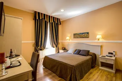 a hotel room with a bed and a desk at PapavistaRelais in Rome