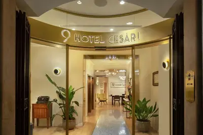 a hotel entrance with a hotel sign on the ceiling at 9Hotel Cesari in Rome