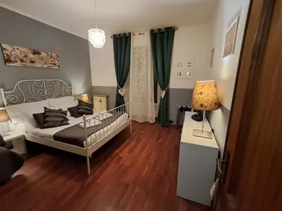 a bedroom with a bed and a table with a lamp at Flaminia 36 Luxury Home in Rome