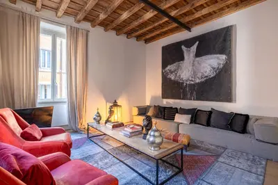a living room with a couch and a table at Fontanella Borghese Lux in Rome