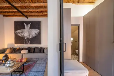 a bedroom with a large white bed with two towels at Fontanella Borghese Lux in Rome
