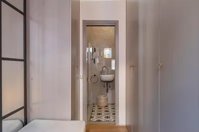 a bedroom with a large white bed with towels on it at Fontanella Borghese Lux in Rome