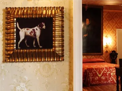 a picture of a dog in a painting on a wall at Antica Dimora dell'Orso in Rome