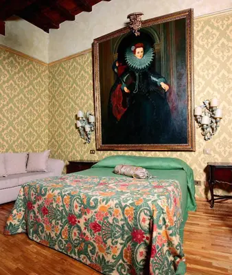 a bedroom with a painting on the wall and a bed at Antica Dimora dell'Orso in Rome