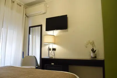 a bedroom with a bed and a television on the wall at Holiday a San Pietro in Rome
