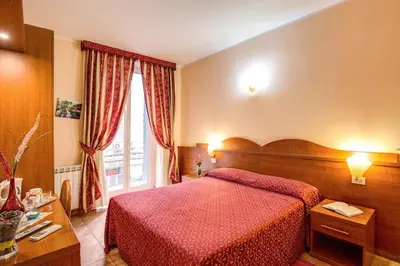 a bedroom with a red bed and a window at Giovy in Rome