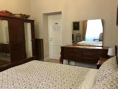 a bedroom with a bed and a dresser and a mirror at Nori Guest House in Rome
