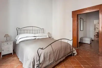 a bedroom with a large bed with white pillows at Antique-Modern Flat by Navona Square in Rome