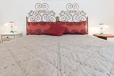 a bedroom with a large bed with red pillows at Flower's Market Apartment - Charme Holidays in Rome