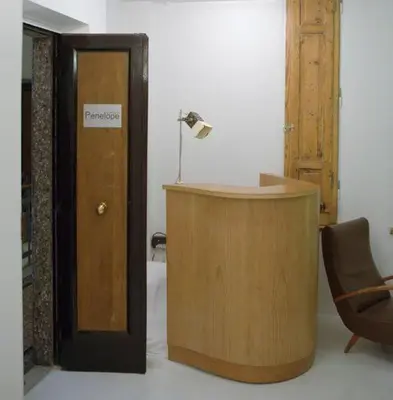 a room with a desk and a door with a lamp at A Casa Di Penelope in Rome