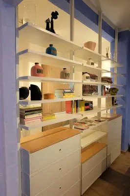 a library with white shelves and books at The Blue Strawberry House in San Giovanni Roma in Rome