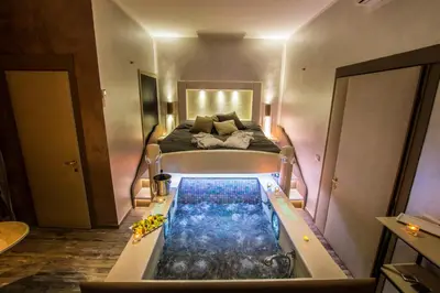 a bedroom with a bed and a bathtub with a tub at Roma d'Amore in Rome