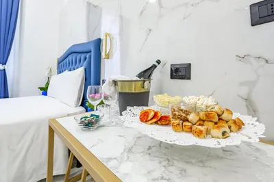 a tray of food on a table next to a bed at Miss Suite in Rome