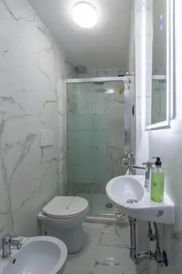 a bathroom with a shower and a toilet and a sink at Miss Suite in Rome