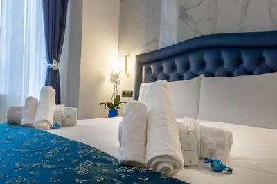 a hotel room with a bed with towels on it at Miss Suite in Rome