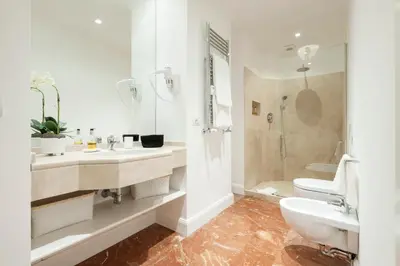 a bathroom with a sink and a toilet and a shower at Lovatelli Home al Campidoglio in Rome