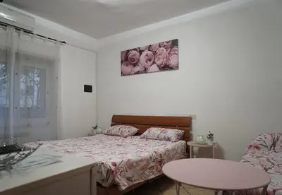 a bedroom with a bed and a table in it at Le Quattro Meraviglie in Rome