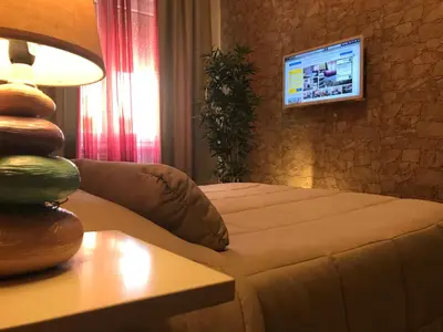 a living room with a couch and a table with a lamp at Appartamento S.Giovanni in Rome