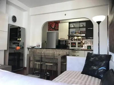 a kitchen with a bar and a dining room at Appartamento S.Giovanni in Rome