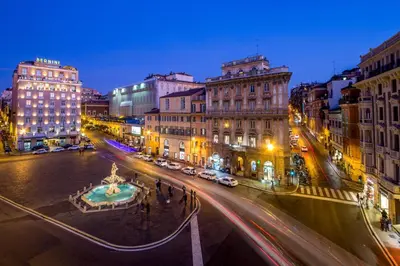 a city street at night with cars on the road at Avignonesi Suites - CA Domus Collection in Rome