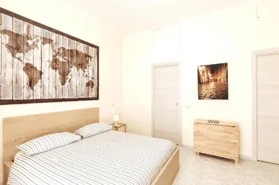 a bedroom with a bed and a map on the wall at Roma Central Studio in Rome
