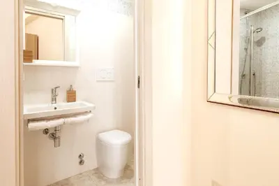 a bathroom with a toilet and a sink and a mirror at Roma Central Studio in Rome