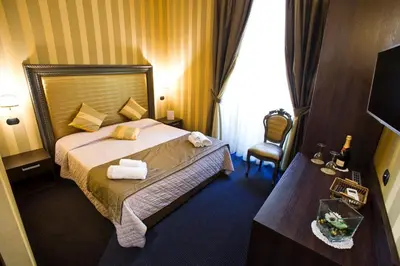 a hotel room with a bed and a chair at Nice Rome Holiday in Rome