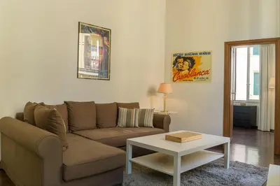 a living room with a couch and a coffee table at GuestHost - Palazzo Borghese Lovely Flat in Rome