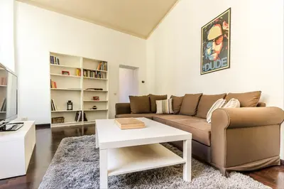 a living room with a couch and a table at GuestHost - Palazzo Borghese Lovely Flat in Rome