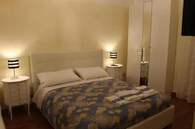 a bedroom with a bed with two night stands and two lamps at Rome Veniero WelcomeHouse in Rome