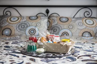 a tray with a box of food on a bed at La Residenza City in Rome