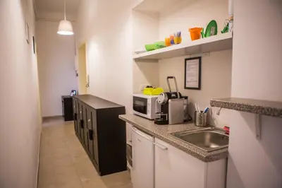 a small kitchen with a sink and a microwave at La Residenza City in Rome
