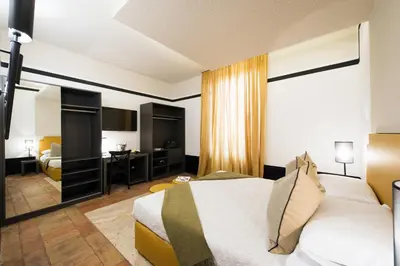 a hotel room with a bed and a desk at Relais Santa Maria Maggiore in Rome